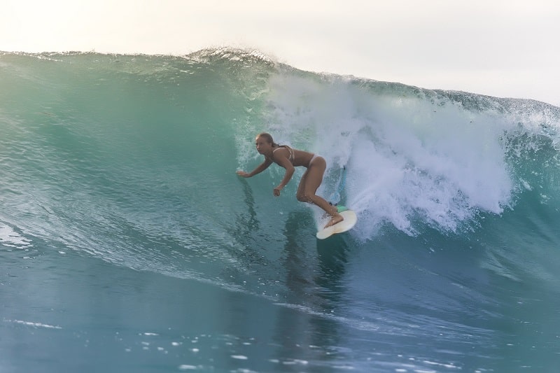 Surfer Girl on a wave in Kuta