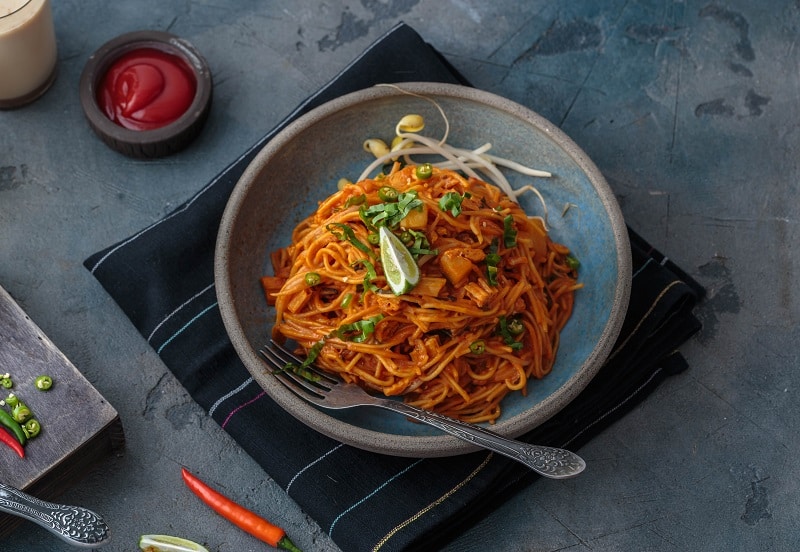 Spicy mee goreng mamak, fried malaysian or singaporean noodles with ketchup and chili