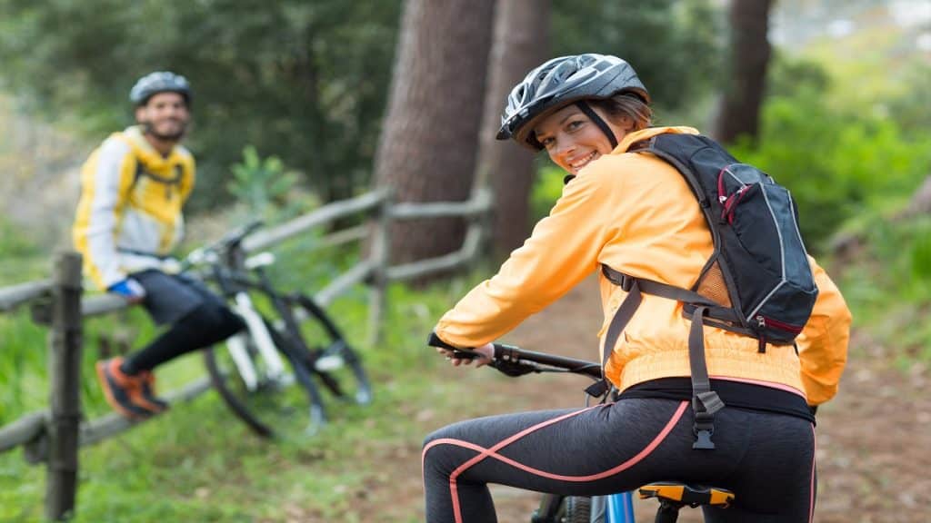 Female biker with mountain bike in countryside