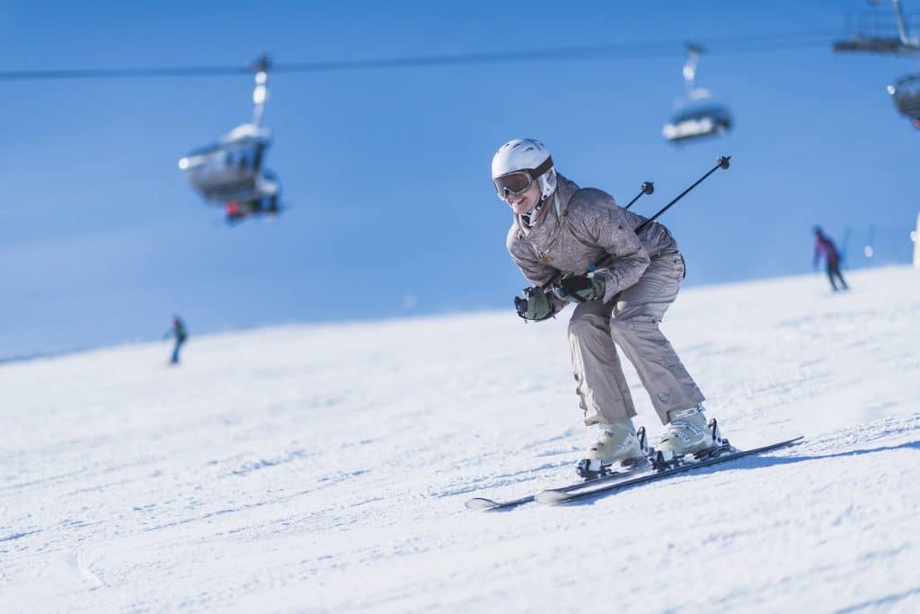 Female skier skiing down the slope