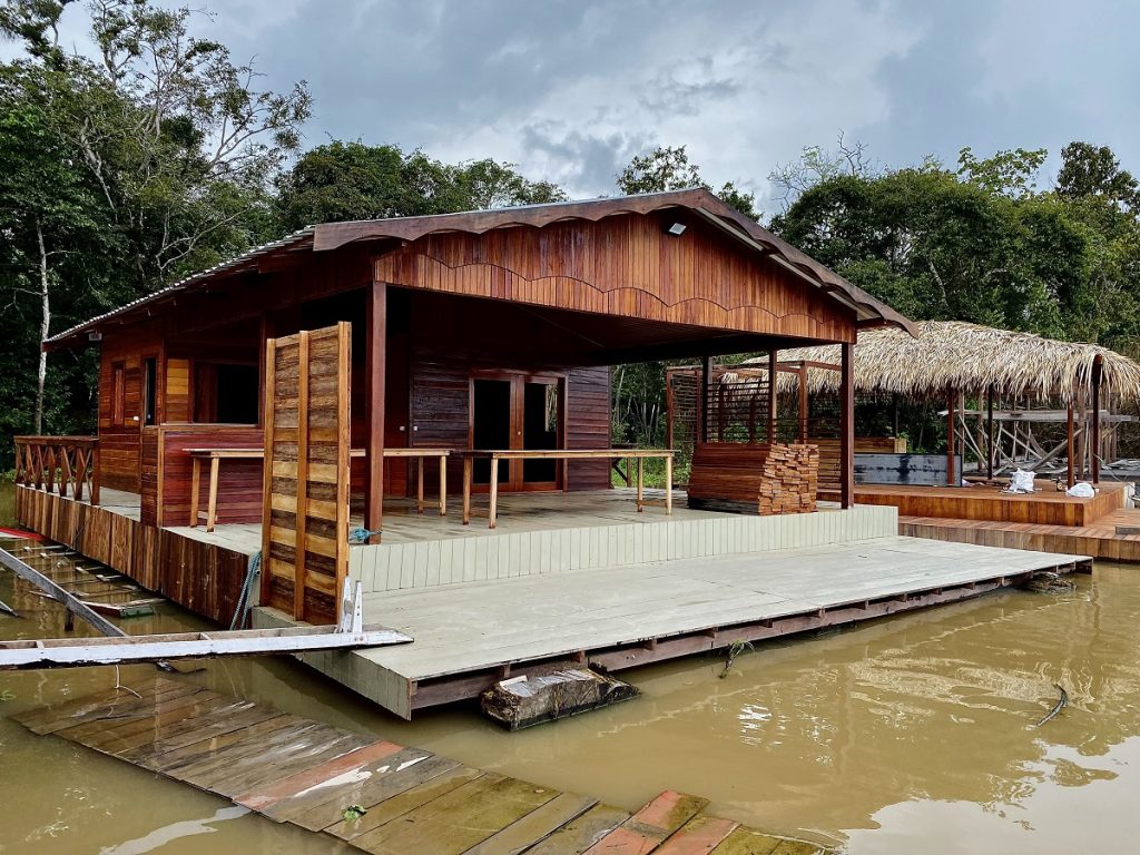 wooden floating house on the amazon river