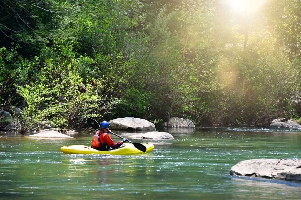 Kayaker Paddling Down a River