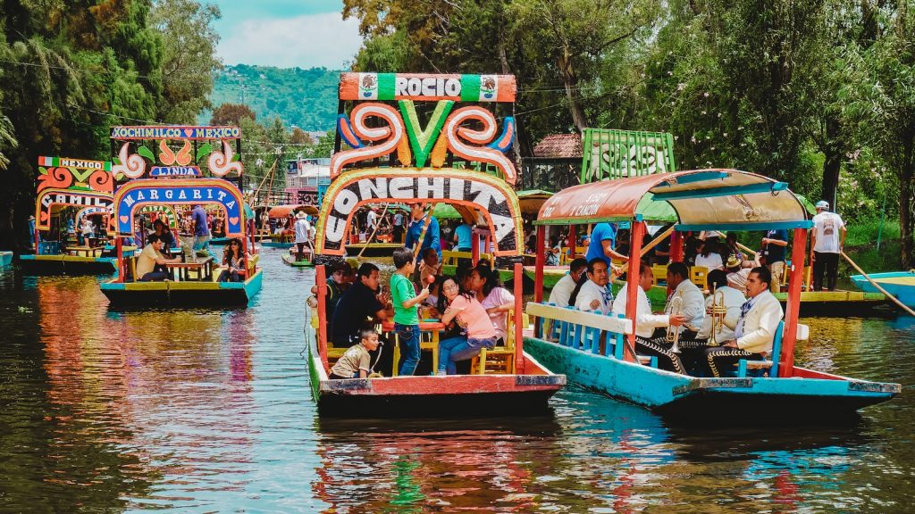 people riding tour boats during daytime in mexico